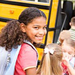 girl boarding a school bus