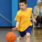 young boy playing basketball