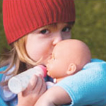 girl kissing her doll