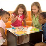 four children playing a board game