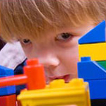 little boy playing with Legos