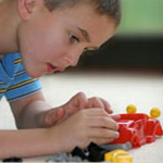 Boy playing with a model race car