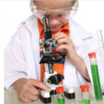Young boy playing with science equipment
