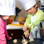 two little girls baking