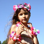 girl dressed in Hawaiian skirt and lei