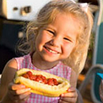 girl eating a hot dog