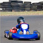 child driving a gocart around a racetrack