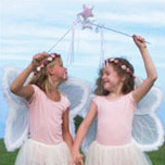 Two girls dressed in pink fairy costumes