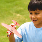 boy flying a model airplane