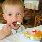 Child eating dessert in a restaurant