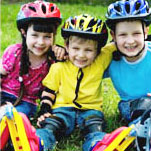 three children roller skating outdoors