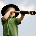 Boy looking through a telescope