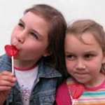 Two girls eating Valentine candy