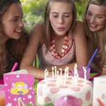 girl blowing out her Sweet 16 cake